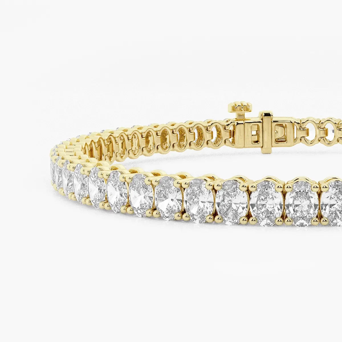 Close-up of oval cut lab diamond tennis bracelet in 14K yellow gold by Delux Jewelry.