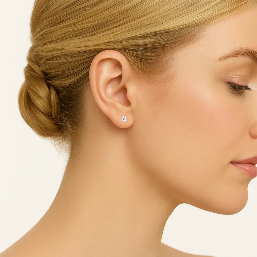 Emerald lab diamond stud earring in 14K white gold worn on woman's ear, Delux Jewelry