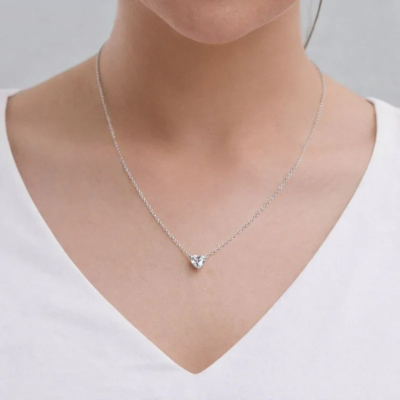 Woman wearing a Delux Jewelry lab grown diamond heart pendant necklace on silver chain
