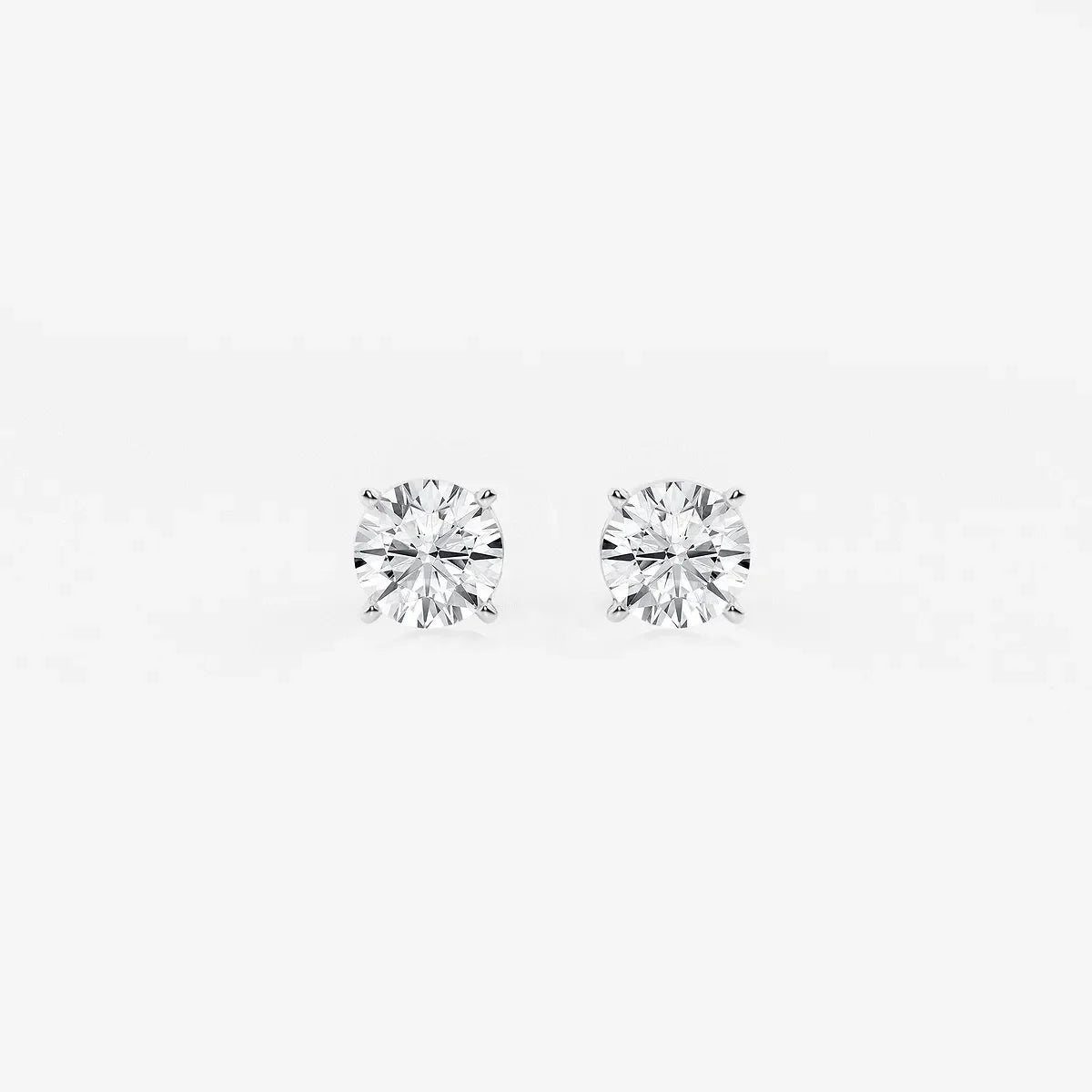 Round lab grown diamond stud earrings on white background from Delux Jewelry