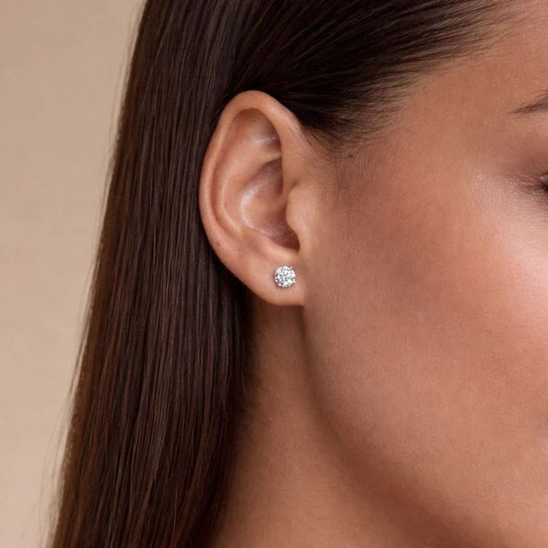 Woman wearing a round lab grown diamond stud earring by Delux Jewelry