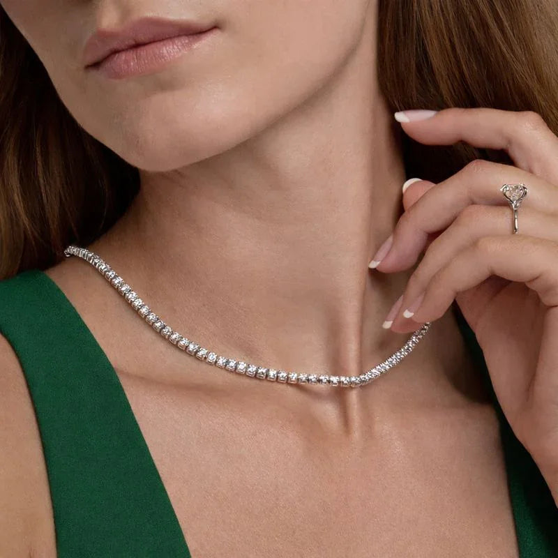 Woman wearing a sterling silver lab diamond tennis chain necklace from Delux Jewelry