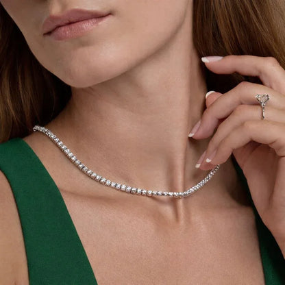 Woman wearing a sterling silver lab diamond tennis chain necklace from Delux Jewelry