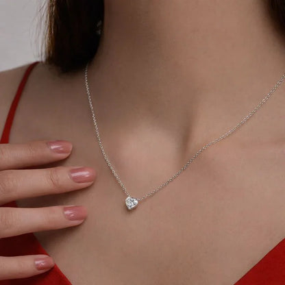 Woman wearing Delux Jewelry heart-shaped lab grown diamond pendant necklace