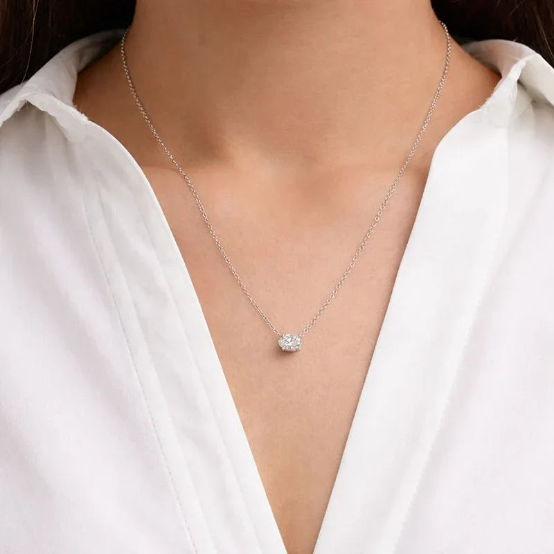Woman wearing delicate lab grown diamond oval pendant necklace by Delux Jewelry