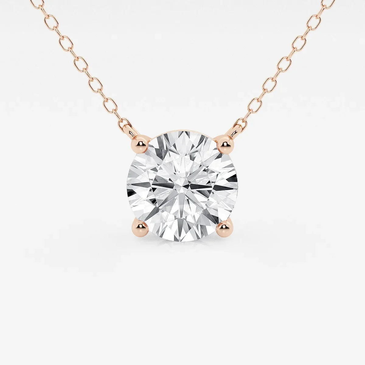 Rose gold necklace with round lab grown diamond pendant on white background