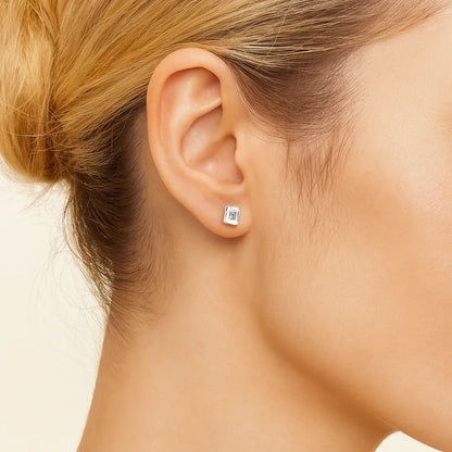 Woman wearing a 14K white gold emerald lab diamond stud earring from Delux Jewelry