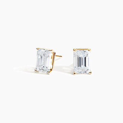 Emerald cut lab diamond stud earrings in 14K yellow gold from Delux Jewelry on white background