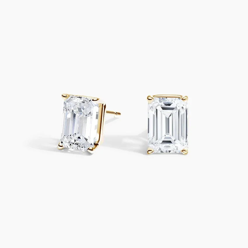 Emerald cut lab diamond stud earrings in 14K yellow gold by Delux Jewelry on white background