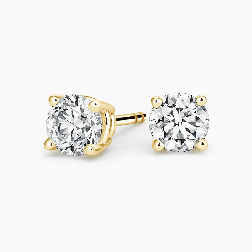 Lab grown diamond stud earrings in 14K yellow gold from Delux Jewelry on white background.