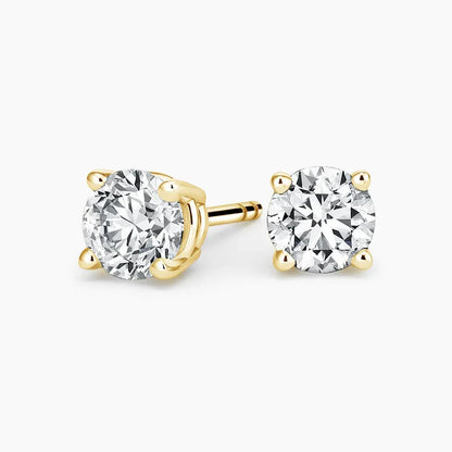 Lab grown diamond stud earrings in 14K yellow gold from Delux Jewelry on white background.