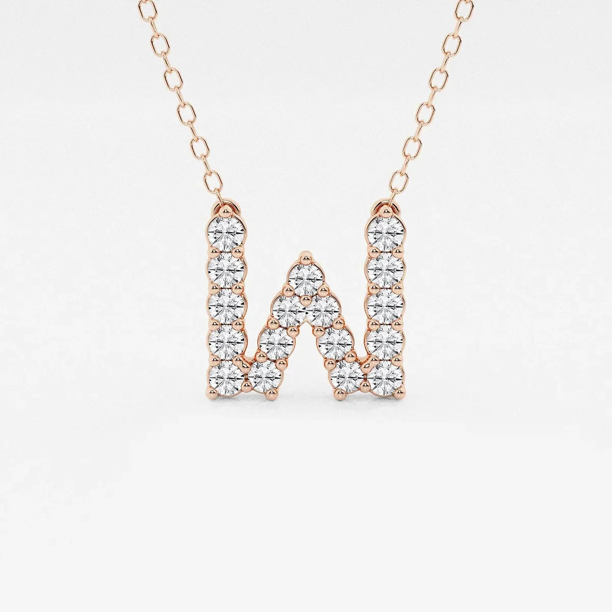 Rose gold necklace with lab grown diamond W initial pendant on a white background