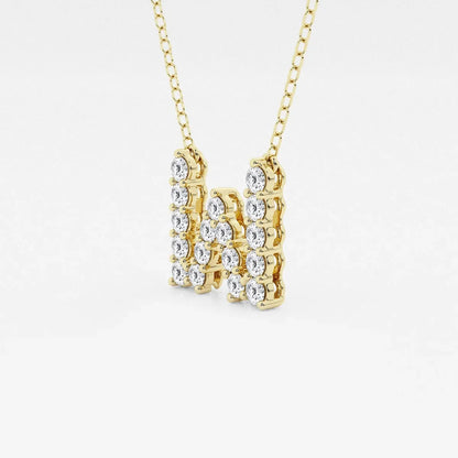 Yellow gold necklace with lab grown diamond letter W pendant on white background