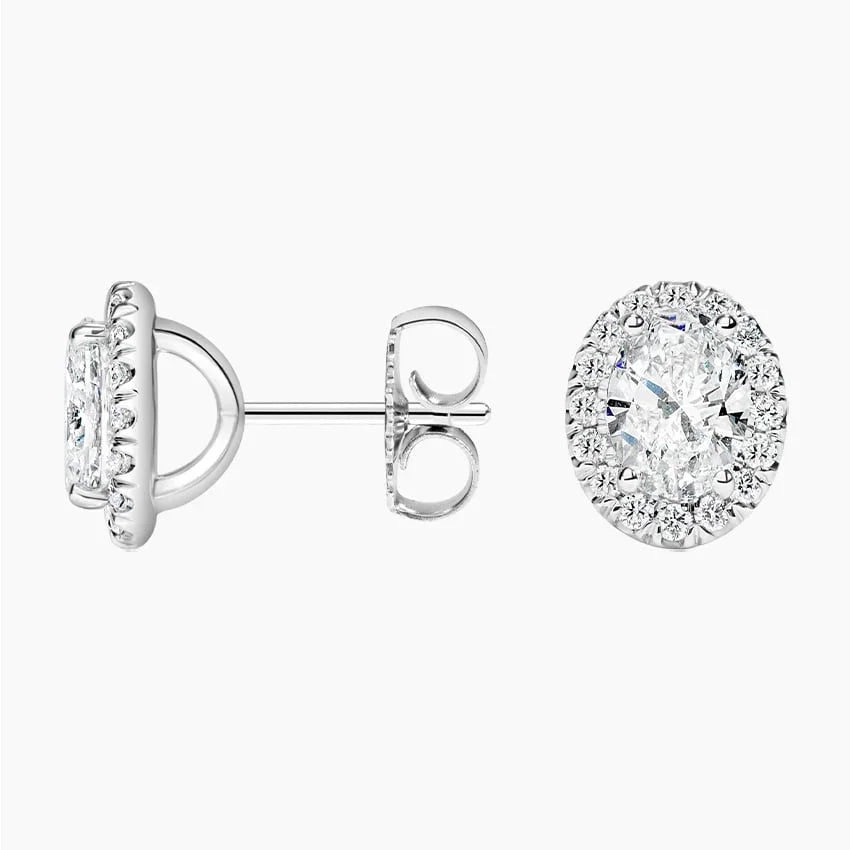 Oval lab grown diamond stud earrings with halo setting in white metal from Delux Jewelry