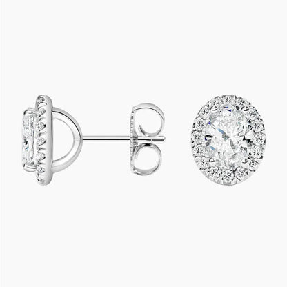 Oval lab grown diamond stud earrings with halo setting in white metal from Delux Jewelry